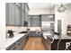 Modern kitchen featuring grey cabinets, stainless steel appliances, a stylish island, and ample counter space at 35348 N 87Th St, Scottsdale, AZ 85266