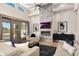 Stylish living room featuring a fireplace, high ceilings, sliding door access to pool, and modern decor at 35348 N 87Th St, Scottsdale, AZ 85266