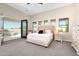 Bright main bedroom featuring plush carpet, patio access with pool view, and neutral decor at 35348 N 87Th St, Scottsdale, AZ 85266
