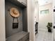 Stylish mudroom with built-in storage, coat hooks, bench, and access to a half bathroom at 35348 N 87Th St, Scottsdale, AZ 85266