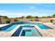 Inviting pool with spa and travertine tile surround offers a luxurious outdoor experience at 35348 N 87Th St, Scottsdale, AZ 85266