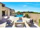 Resort style backyard featuring a beautiful pool, spa, and comfortable seating around a fire pit at 35348 N 87Th St, Scottsdale, AZ 85266