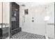 Close-up of modern walk-in shower with white marble tile and black accent tile detailing at 35348 N 87Th St, Scottsdale, AZ 85266