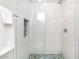 Modern shower features white subway tile, niche and colorful patterned floor at 35348 N 87Th St, Scottsdale, AZ 85266
