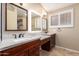 Elegant bathroom featuring a double sink vanity with granite countertops, and custom cabinets at 3690 N 150Th Ave, Goodyear, AZ 85395
