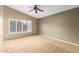 Spacious bedroom with neutral carpet, a large window with shutters and a ceiling fan at 3690 N 150Th Ave, Goodyear, AZ 85395