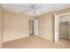 Bedroom featuring ceiling fan and view into the walk-in closet at 3690 N 150Th Ave, Goodyear, AZ 85395