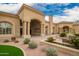 Exterior of the community clubhouse with manicured landscaping, benches, and a grand entrance at 3690 N 150Th Ave, Goodyear, AZ 85395