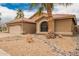 Well-maintained home features desert landscaping, a tile roof, a two-car garage, and a palm tree at 3690 N 150Th Ave, Goodyear, AZ 85395