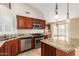 Updated kitchen featuring granite countertops, stainless steel appliances, and a center island at 3690 N 150Th Ave, Goodyear, AZ 85395