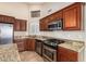 Updated kitchen with granite countertops, stainless steel appliances, and custom wood cabinets at 3690 N 150Th Ave, Goodyear, AZ 85395