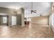 Spacious living room with tile flooring, ceiling fans, and access to the kitchen at 3690 N 150Th Ave, Goodyear, AZ 85395