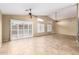 Bright living room with tile floors, vaulted ceiling, sliding glass doors, and plantation shutters at 3690 N 150Th Ave, Goodyear, AZ 85395