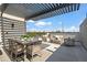Spacious rooftop patio with an outdoor dining and lounge area under a modern pergola at 377 E Windsor Ave # 4, Phoenix, AZ 85004