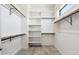 Bright, walk-in closet with white shelving, tile flooring, and ample storage space at 377 E Windsor Ave # 4, Phoenix, AZ 85004