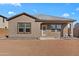 Exterior of a home with a desert landscaped backyard featuring a covered patio and ample space for entertaining at 393 S Soledad Ln, Casa Grande, AZ 85194