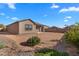Spacious backyard with desert landscaping, offering a tranquil and low-maintenance outdoor space at 393 S Soledad Ln, Casa Grande, AZ 85194