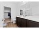 Clean bathroom with a modern vanity, a large mirror, and a glimpse into the walk-in closet at 393 S Soledad Ln, Casa Grande, AZ 85194