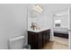 Well-lit bathroom with a vanity, a large mirror, and an adjoining room view, creating an open feel at 393 S Soledad Ln, Casa Grande, AZ 85194