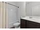 Bright bathroom featuring a shower-tub combo with a white shower curtain, a dark vanity, and modern fixtures at 393 S Soledad Ln, Casa Grande, AZ 85194