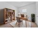 Charming office space with a light wood desk, a bookshelf, and a cozy rug, offering a perfect work-from-home setting at 393 S Soledad Ln, Casa Grande, AZ 85194