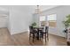 Bright dining area with wood floors, a modern chandelier, and a charming table with seating for four at 393 S Soledad Ln, Casa Grande, AZ 85194