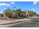 Corner lot home with lush landscaping and a well-maintained yard and long driveway and a neutral color stucco at 393 S Soledad Ln, Casa Grande, AZ 85194