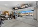 Spacious two-car garage with ample storage and an open door, revealing neighborhood views at 393 S Soledad Ln, Casa Grande, AZ 85194