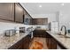 Modern kitchen with stainless steel appliances, granite countertops, and dark wood cabinets at 393 S Soledad Ln, Casa Grande, AZ 85194