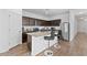 Modern kitchen features dark cabinetry, stainless steel appliances, granite countertops, and breakfast bar at 393 S Soledad Ln, Casa Grande, AZ 85194