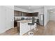 Modern kitchen with stainless steel appliances, granite countertops, and a breakfast bar with bar seating at 393 S Soledad Ln, Casa Grande, AZ 85194
