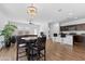 Open-concept living room and kitchen with a modern island, stylish lighting, and wood flooring at 393 S Soledad Ln, Casa Grande, AZ 85194