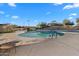 Community pool with a slide, lounge chairs, and sunshades, set against a backdrop of palm trees under a sunny sky at 393 S Soledad Ln, Casa Grande, AZ 85194