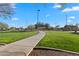 Scenic community walking path winds through green space with nearby play areas and neighborhood amenities at 393 S Soledad Ln, Casa Grande, AZ 85194