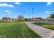 Scenic community walking path with shaded picnic benches, a volleyball court, and gorgeous green space at 393 S Soledad Ln, Casa Grande, AZ 85194