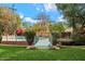 Lush backyard featuring a unique bridge leading to the sparkling pool, surrounded by mature trees and greenery at 4010 E Montebello Ave, Phoenix, AZ 85018