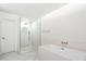 Bright bathroom with glass shower, modern soaking tub and beautiful marble floors at 4010 E Montebello Ave, Phoenix, AZ 85018