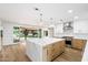 Open concept kitchen and living area with a large island and sliding doors to the backyard at 4010 E Montebello Ave, Phoenix, AZ 85018