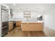 Modern kitchen with stainless steel appliances, a center island, and white cabinetry at 4010 E Montebello Ave, Phoenix, AZ 85018