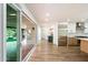 Open living space with a sliding glass door to the patio and a view into the modern kitchen at 4010 E Montebello Ave, Phoenix, AZ 85018