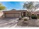 Charming single-story home featuring a three-car garage, desert landscaping, and a tile roof at 4039 E Williams Dr, Phoenix, AZ 85050