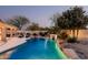 Inviting pool area with mature landscaping and a relaxing waterfall feature at 4039 E Williams Dr, Phoenix, AZ 85050