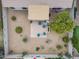 Aerial view of a backyard featuring a paver patio, seating, desert landscaping, and mature trees, creating a serene outdoor space at 4365 E Briles Rd, Phoenix, AZ 85050