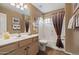 Bathroom featuring vanity, sink, tiled floor, and a shower-tub combination with curtain at 4365 E Briles Rd, Phoenix, AZ 85050