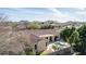 An aerial view shows the pool and patio, as well as mountain views from the desert neighborhood at 4614 W Fallen Leaf Ln, Glendale, AZ 85310