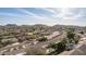 An aerial view shows the community featuring Southwestern style homes in a planned community near mountain landscapes at 4614 W Fallen Leaf Ln, Glendale, AZ 85310