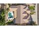 A birds-eye view captures the home's unique shape with a pool, patio, and tile roof at 4614 W Fallen Leaf Ln, Glendale, AZ 85310