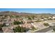 An aerial view displays desert neighborhood homes with red tile roofs, landscaped yards, and mountain views at 4614 W Fallen Leaf Ln, Glendale, AZ 85310