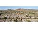 An aerial view of Southwestern style homes in a planned community with desert landscaping and mountain views at 4614 W Fallen Leaf Ln, Glendale, AZ 85310