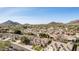 An aerial view showing a neighborhood featuring Southwestern homes with red tile roofs near desert mountains at 4614 W Fallen Leaf Ln, Glendale, AZ 85310